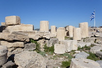 Greece, Attica, Athens, Acropolis ruins with tourists and large Greek flag.