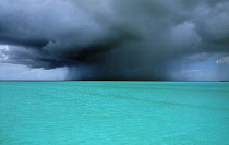 West Indies, Turks and Caicos Island, Storm clouds over turquoise sea.