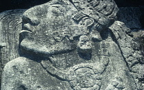 Mexico, Chiapas, Palenque, Carved stone slab depicting the priests head with sun necklace in the courtyard of the Palace.