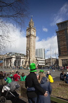 Ireland, North, Belfast, St Patricks Day parade passing the Albert clock on the corner of High Street and Victoria Street.