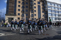 Ireland, North, Belfast, St Patricks Day parade passing the Albert clock on the corner of High Street and Victoria Street.