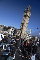 Ireland, North, Belfast, St Patricks Day parade passing the Albert clock on the corner of High Street and Victoria Street.