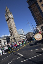 Ireland, North, Belfast, St Patricks Day parade passing the Albert clock on the corner of High Street and Victoria Street.