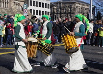 Ireland, North, Belfast, St Patricks Day parade passing the Albert clock on the corner of High Street and Victoria Street.