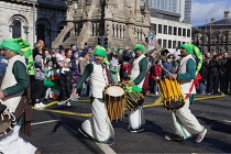 Ireland, North, Belfast, St Patricks Day parade passing the Albert clock on the corner of High Street and Victoria Street.