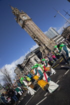 Ireland, North, Belfast, St Patricks Day parade passing the Albert clock on the corner of High Street and Victoria Street.