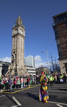 Ireland, North, Belfast, St Patricks Day parade passing the Albert clock on the corner of High Street and Victoria Street.