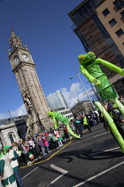 Ireland, North, Belfast, St Patricks Day parade passing the Albert clock on the corner of High Street and Victoria Street.