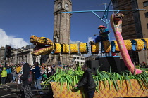 Ireland, North, Belfast, St Patricks Day parade passing the Albert clock on the corner of High Street and Victoria Street.