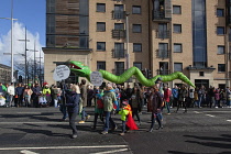 Ireland, North, Belfast, St Patricks Day parade passing the Albert clock on the corner of High Street and Victoria Street.