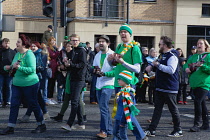 Ireland, North, Belfast, St Patricks Day parade passing the Albert clock on the corner of High Street and Victoria Street.