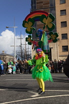 Ireland, North, Belfast, St Patricks Day parade passing the Albert clock on the corner of High Street and Victoria Street.