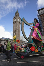 Ireland, North, Belfast, St Patricks Day parade passing the Albert clock on the corner of High Street and Victoria Street.