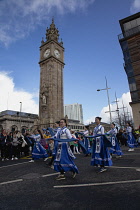 Ireland, North, Belfast, St Patricks Day parade passing the Albert clock on the corner of High Street and Victoria Street.