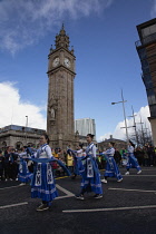 Ireland, North, Belfast, St Patricks Day parade passing the Albert clock on the corner of High Street and Victoria Street.