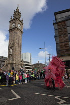 Ireland, North, Belfast, St Patricks Day parade passing the Albert clock on the corner of High Street and Victoria Street.