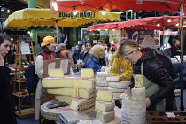 England, London, Southwark, Borough Market, Cheese seller with tourist buying.