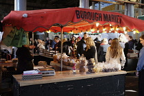 England, London, Southwark, Borough Market, Chocolate vendor with tourists buying.