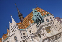 Hungary, Budapest, Matthias Church, Detail of the colourful majolica roof tiles with statue of King Saint Stephen founder of the Hungarian state on horseback.