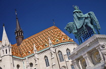 Hungary, Budapest, Matthias Church, Detail of the colourful majolica roof tiles with statue of King Saint Stephen founder of the Hungarian state on horseback.