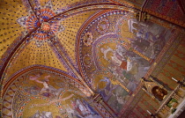 Hungary, Budapest, Matthias Church, Interior detail of the colourful walls and ceiling and an altar.