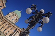 Hungary, Budapest, Angular view of Buda Castle and its spectacular dome with a street lamp in the foreground.