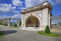 Hungary, Budapest, Castle Hill, the newly renovated Varkert Bazaar (Castle Garden Bazaar), a Neoclassical building complex on the western bank of the River Danube with the Parliament Building in the far background.