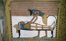 Egypt, Nile Valley, Thebes, Deir al Bahri  Temple of Sesedjem.  Detail of mural depicting Anubis the jackel headed god of the dead performing a ritual over a mummified corpse.