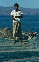 Qatar, General, Fisherman mending net.