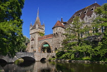 Hungary, Budapest, Vajdahunyad Castle, entrance gate to the castle over a small stream.