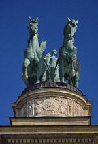 Hungary, Budapest, Heroes Square, The Millennium colonnade with a female figure on a chariot representing Peace.