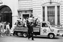 England, London, Gay Pride parade, Pall Mall, 1979, 30 June, demonstrators, peaceful protest, Ford Transit carnival float. Metroplitan police escort, banners, Press.
