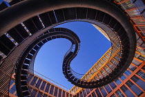 Germany, Bavaria, Munich, Angular view from below of a section of The Endless or Infinite Staircase sculpture by Olafur Eliasson with KPMG offices behind..