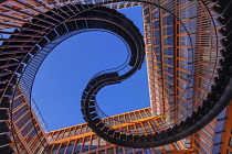 Germany, Bavaria, Munich, Angular view from below of a section of The Endless or Infinite Staircase sculpture by Olafur Eliasson with KPMG offices behind..