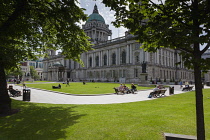 Ireland, North, Belfast, People relaxing on the City Hall lawns.