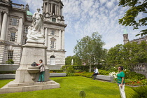 Ireland, North, Belfast, Tourists photographing the Titanic memorial in the grounds of the City Hall.