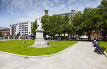 Ireland, North, Belfast, People relaxing on the City Hall lawns in summer.