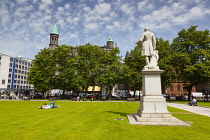 Ireland, North, Belfast, People relaxing on the City Hall lawns in summer.