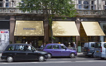 Ireland, North, Belfast, Taxi cabs outside Cafe Parisien in the former Robinson & Cleaver building.