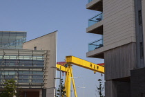 Ireland, North, Belfast, Titanic Quarter, Modern apartment buildings with Harland and Wolff cranes in the background.