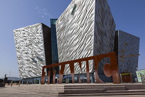 Ireland, North, Belfast, Titanic Quarter, Visitor centre designed by Civic Arts & Eric R Kuhne, with statue of diving woman in foreground.