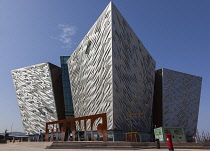 Ireland, North, Belfast, Titanic Quarter, Visitor centre designed by Civic Arts & Eric R Kuhne, with statue of diving woman in foreground.