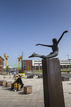 Ireland, North, Belfast, Titanic Quarter, Visitor centre designed by Civic Arts & Eric R Kuhne, with statue of diving woman in foreground.