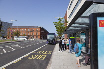 Ireland, North, Belfast, Titanic Quarter, Tourists awaiting Glider rapid transit bus.