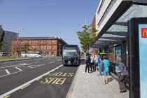 Ireland, North, Belfast, Titanic Quarter, Tourists awaiting Glider rapid transit bus.