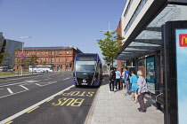 Ireland, North, Belfast, Titanic Quarter, Tourists awaiting Glider rapid transit bus.