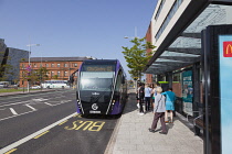 Ireland, North, Belfast, Titanic Quarter, Tourists awaiting Glider rapid transit bus.