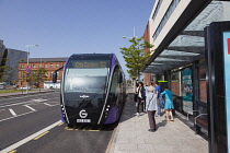 Ireland, North, Belfast, Titanic Quarter, Tourists awaiting Glider rapid transit bus.