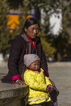 A Khamba Tibetan woman from the Kham region of eastern Tibet with her daughter.  Lhasa, Tibet,