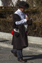 A Tibetan Buddhist pilgrim from the Kham region of eastern Tibet visits the Potala Palace in Lhasa, Tibet.